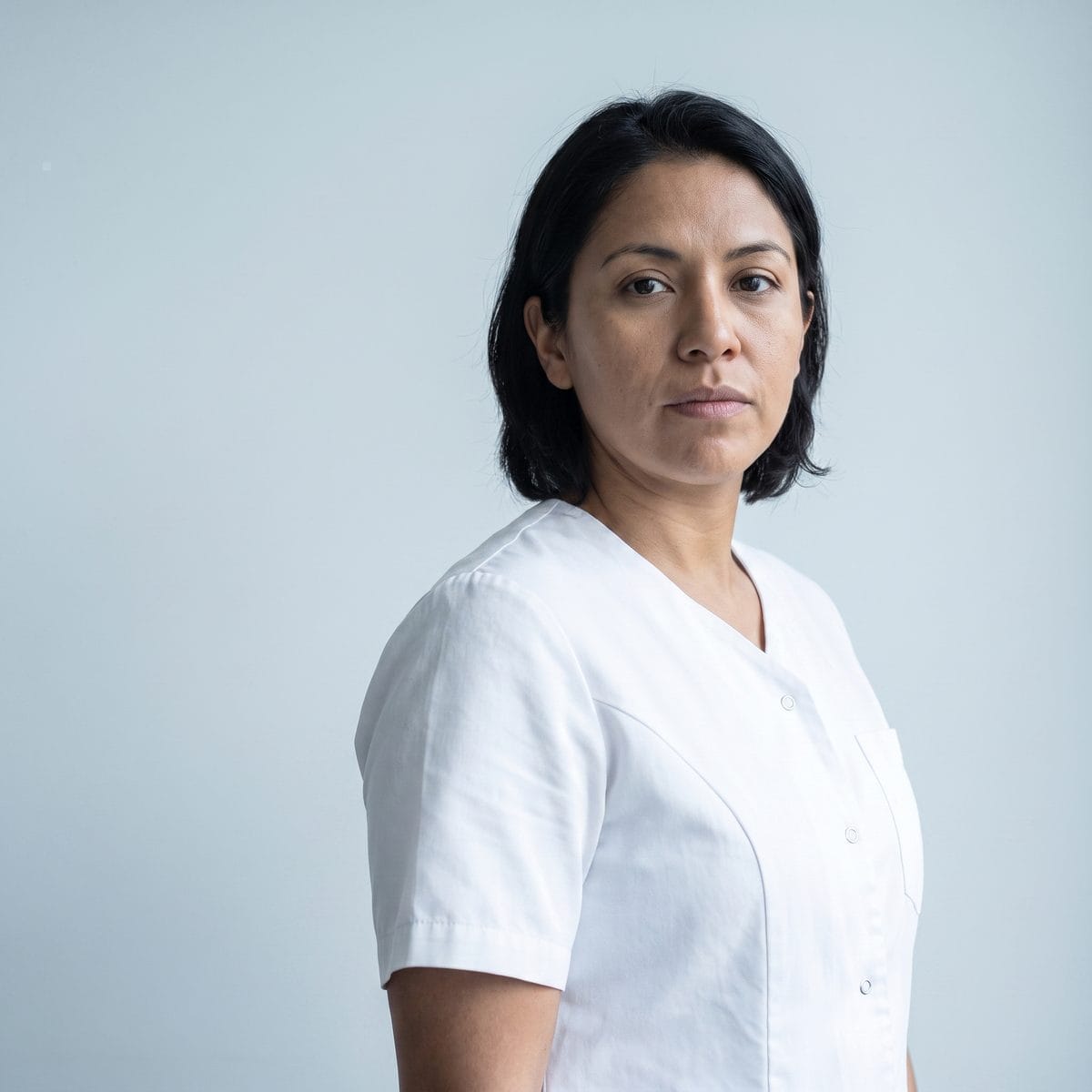Portrait of one of the practice's nurse injectors against a plain pale background.