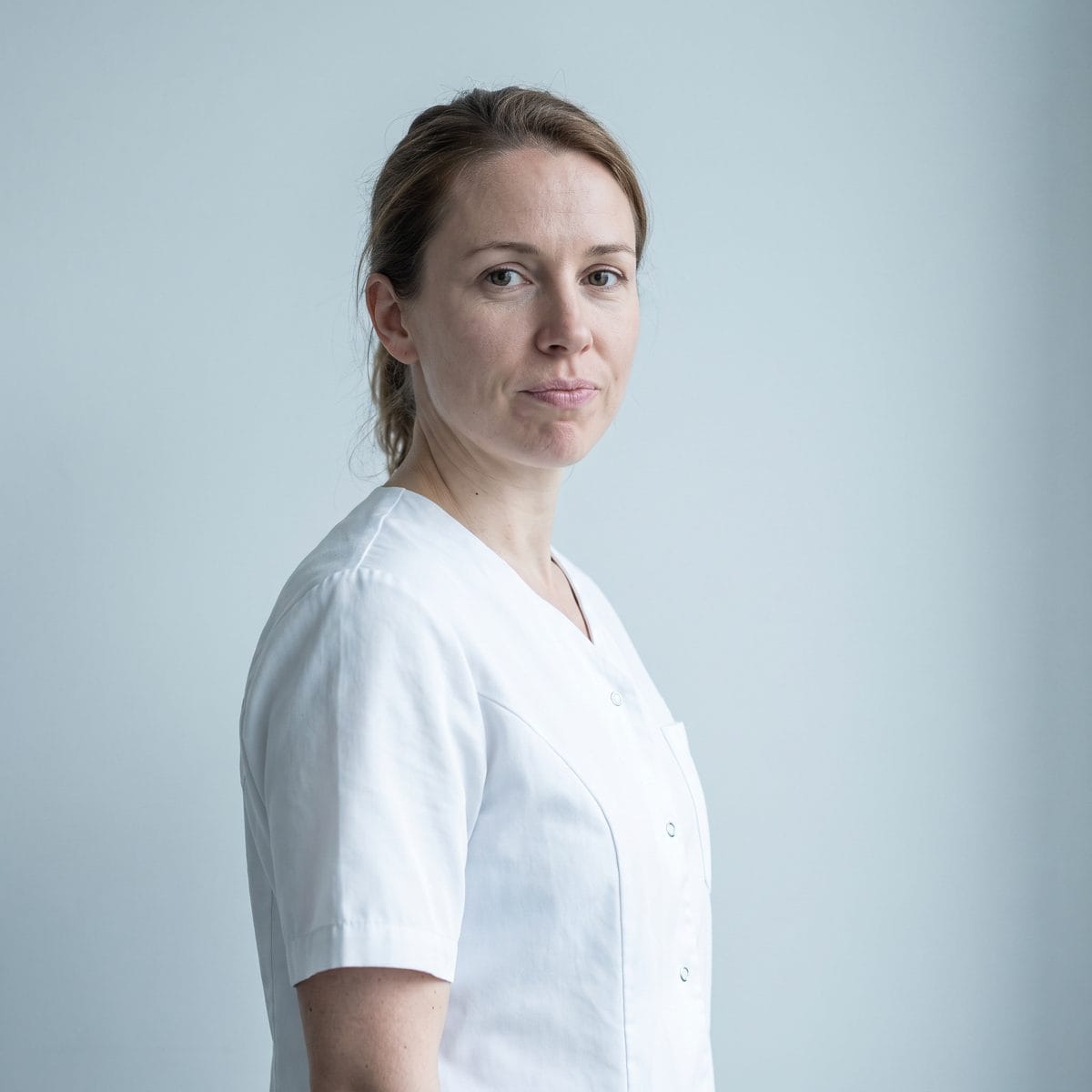 Portrait of the practice's founder against a plain pale background.