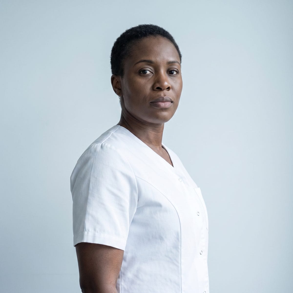 Portrait of the practice's lead medical aesthetician against a plain pale background.